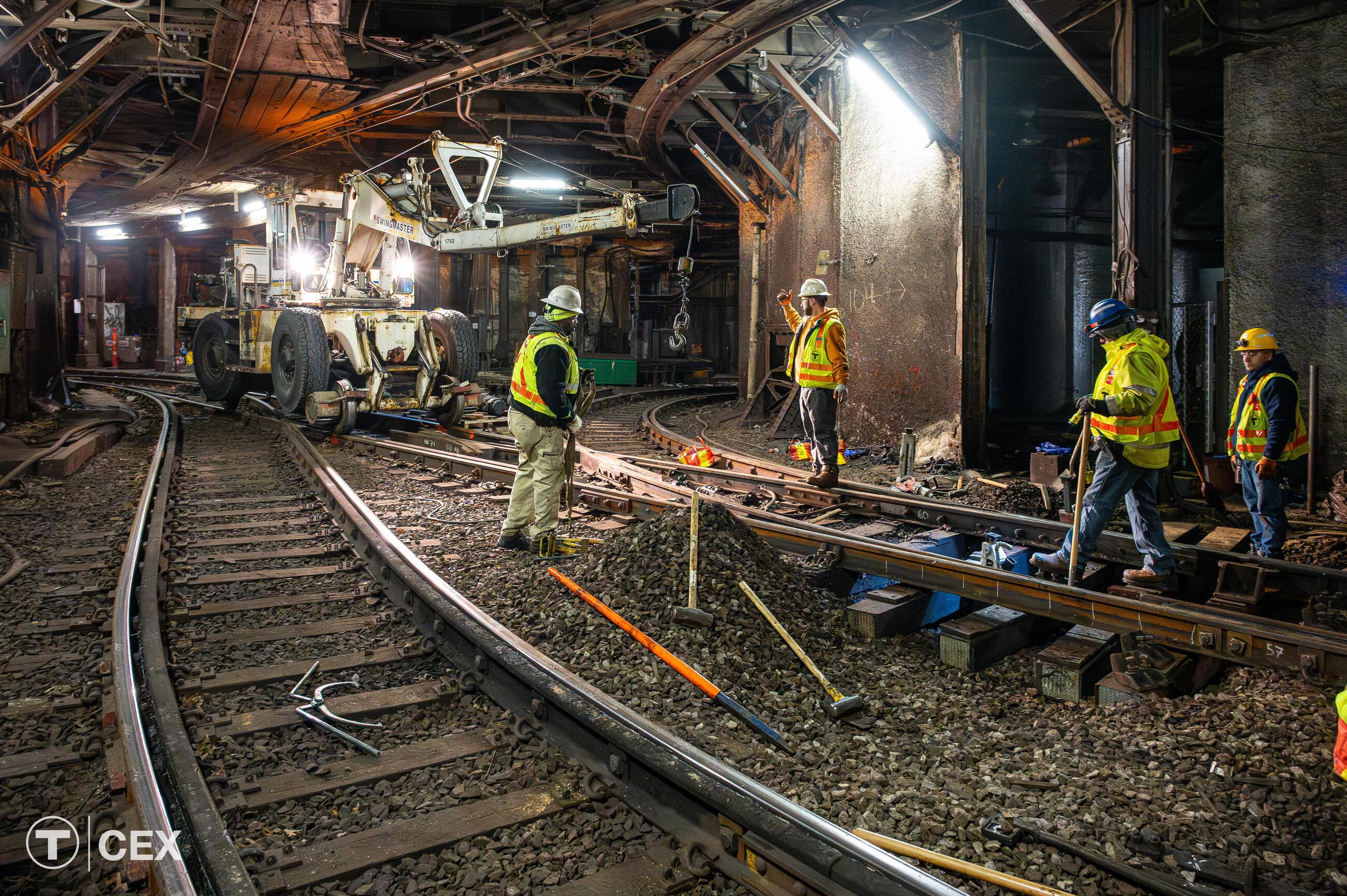 MBTA construction workers performing track maintenance and signal upgrades in underground tunnel